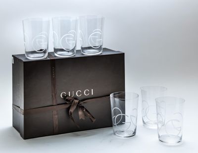four glasses in a box with a ribbon around them