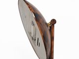 a close up of a clock on a stand on a white background