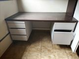 an image of a desk with drawers in a room