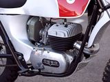 a red and white motorcycle parked on the side of the road