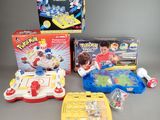 toys and games are sitting on a gray surface with a gray background