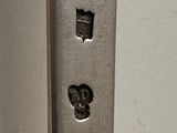 a close up of a metal object with a face on it