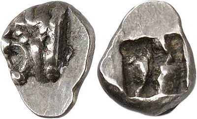a close up of a silver coin with a face on it