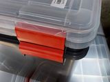 several plastic containers are stacked on top of each other on a table