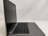 an open laptop computer sitting on top of a white surface