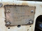 a metal plaque on the side of an old machine