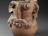 an image of a clay vase with a face on it