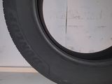 tire on the floor of a garage with a white wall in the background
