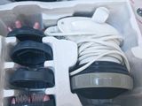 a box with a pair of shoes and a hair brush in it