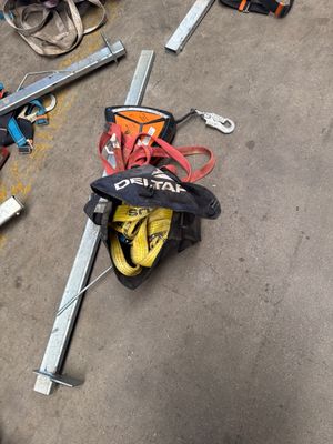 several pairs of skis and ski poles laying on the ground