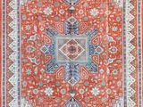 an orange and blue rug with a medallion design