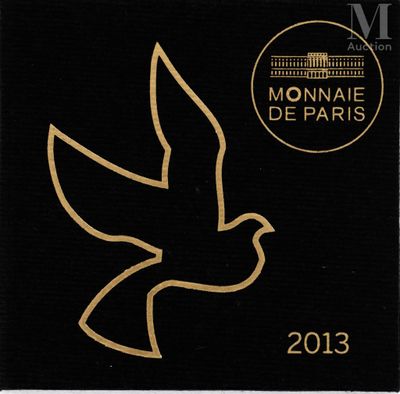 a close up of a black and gold stamp with a bird on it