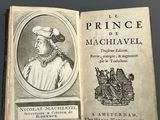 an old book with a picture of a man in a hat on top of it
