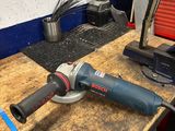 a picture of a sander on a workbench in a workshop