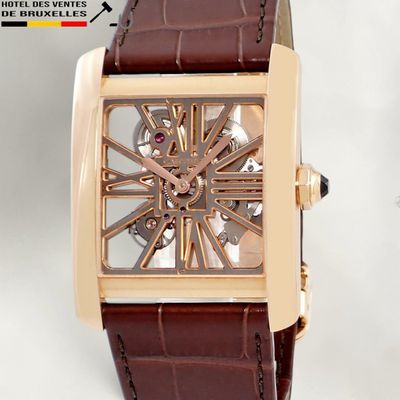 a brown strap around the wrist of a watch
