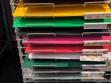 a lot of folders that are stacked up on a rack