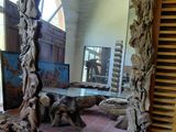 a large mirror that is made out of drift wood
