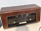 an old radio sitting on a table next to a mouse