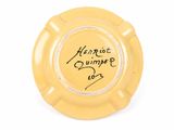 an image of a yellow ashtray with writing on it
