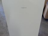 a white refrigerator that is sitting in the middle of a room