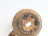 a brown vase with a white tag on it