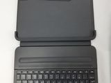 a laptop with a black keyboard on a white table
