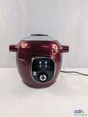 an image of a red rice cooker sitting on a white surface