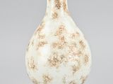an image of a white vase with a brown design on it
