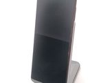 a cell phone that is sitting on top of a stand