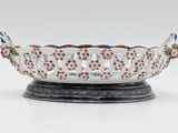 a white bowl with red, blue, and green designs on it