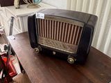 an old radio sitting on top of a wooden table