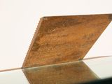 a piece of wood sitting on top of a glass table