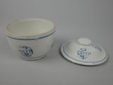 a small cup and saucer sitting next to each other