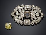 an antique diamond broochle and a yellow diamond