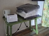 a green table with a television and a microwave on it