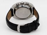 a close up of a watch on a white surface with a black strap