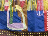 a colorful wall hanging with a picture of a man on a horse