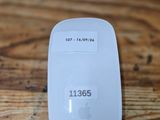 a white apple mouse sitting on top of a wooden table
