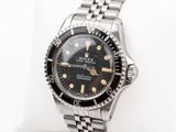 an image of a rolex watch sitting on a white pillow