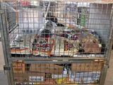 a metal cage with food inside of it in a warehouse