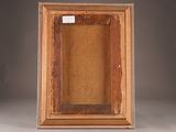 an old wooden picture frame with a label on it