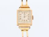 an image of a gold wrist watch on a white background