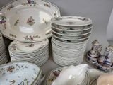 a lot of plates and bowls that are on the table