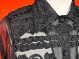 a close up of a black dress on a mannequin