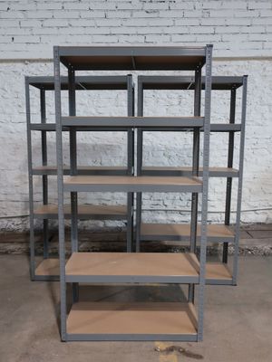 a set of four metal shelvings in a warehouse