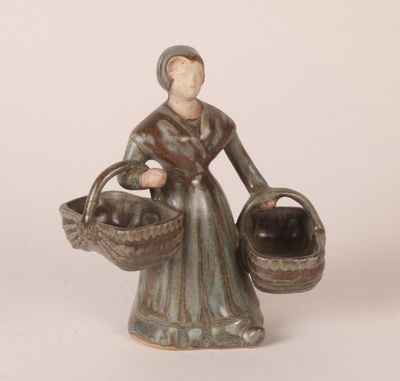 figurine of a woman with a basket of apples