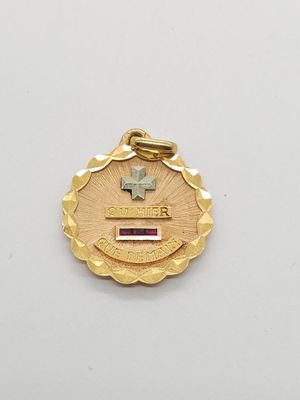 a close up of a medal with a cross on it