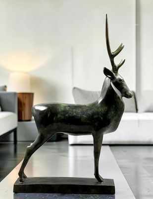 a statue of a deer on a table in a living room