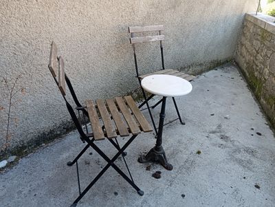 a small table and two chairs on a patio