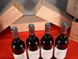 several bottles of wine are lined up on a red table